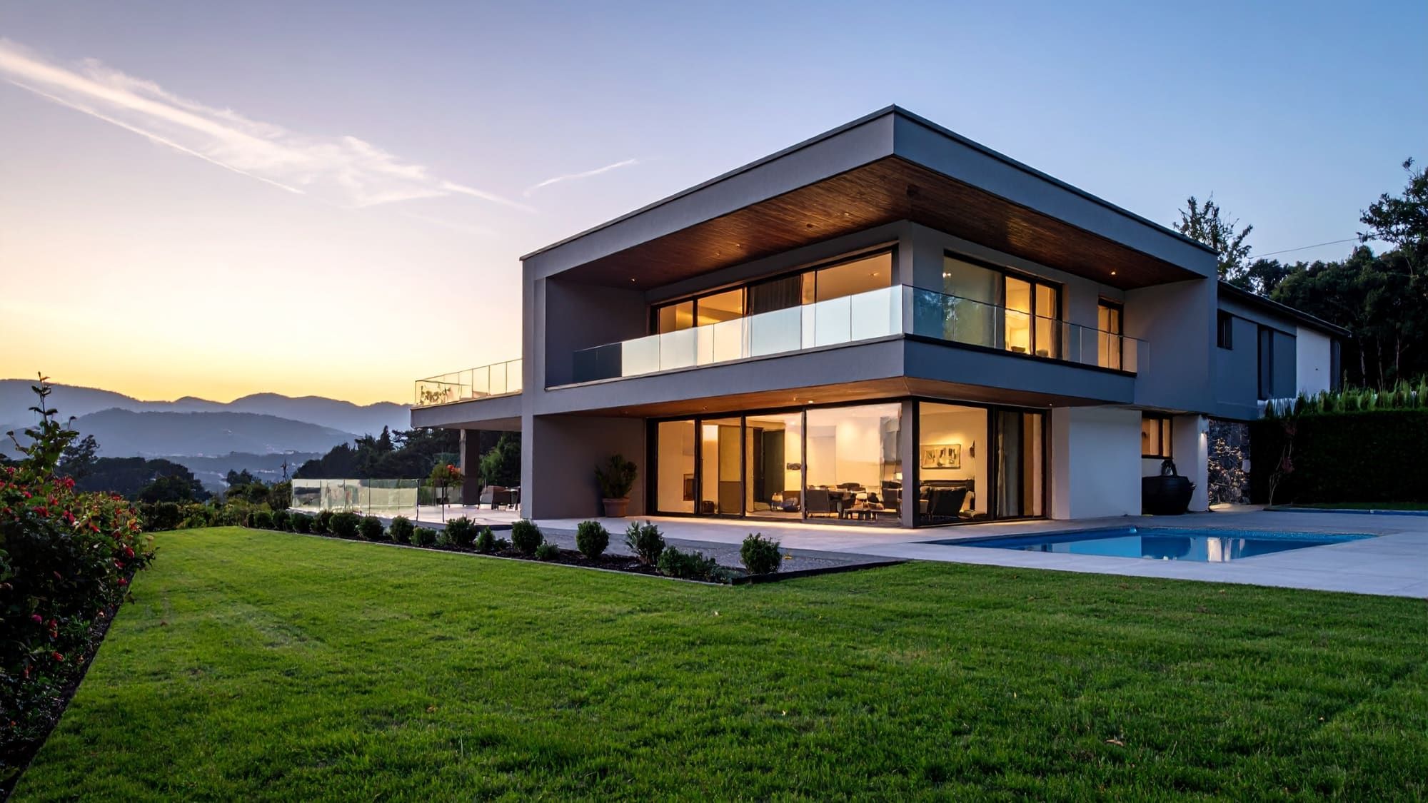 Modern hillside home at sunset with mountain views, shot for a luxury listing