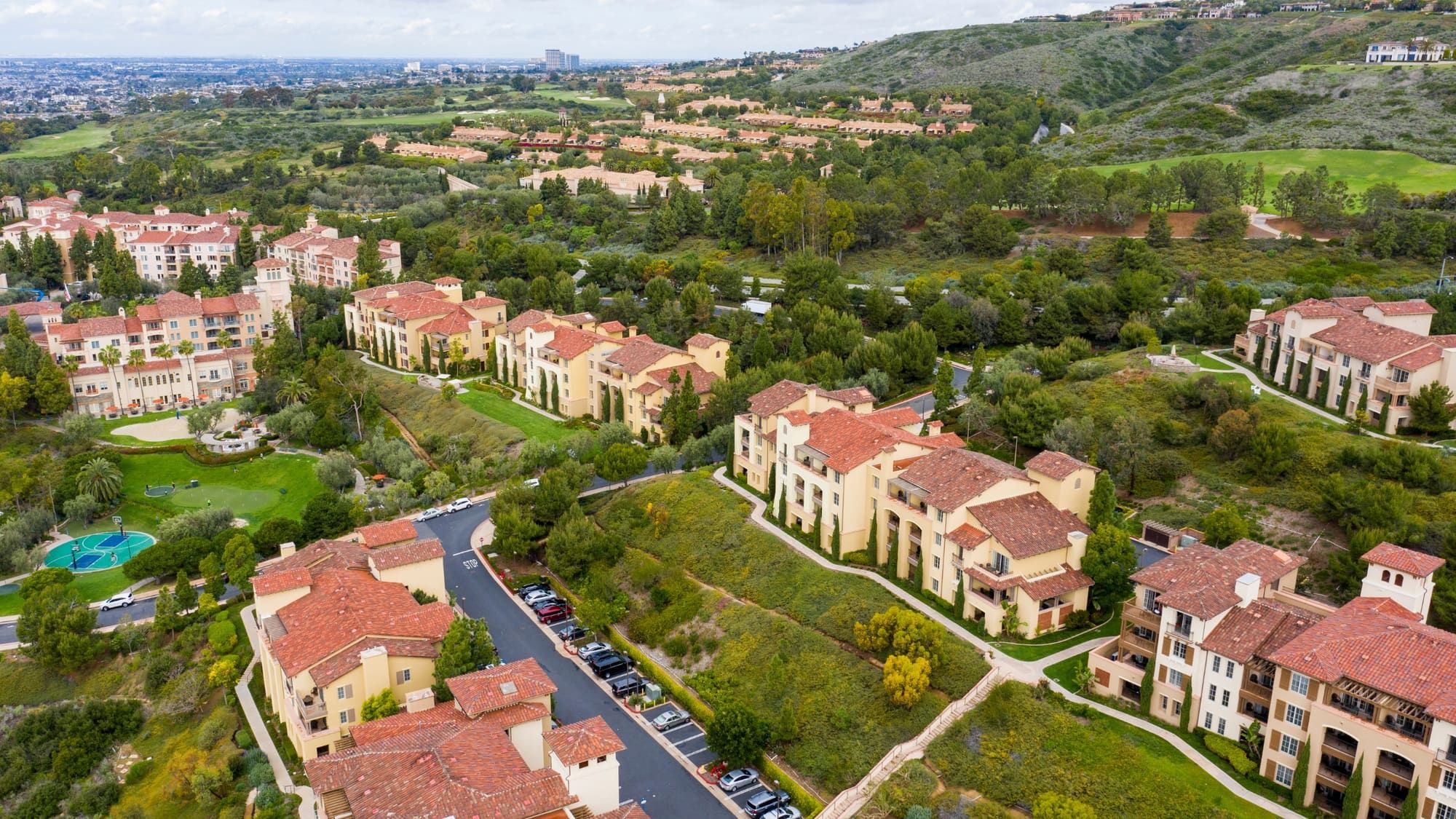 Drone photo of Newport Coast condominium communities and golf course greens